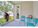 Screened lanai with comfortable seating and views of the community's lawn at 803 Oak Bend Ln, Dunedin, FL 34698