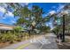 A street view of shops and a trail crossing in Dunedin, Florida, under a sunny blue sky at 803 Oak Bend Ln, Dunedin, FL 34698