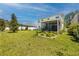 Expansive backyard features a well-manicured lawn and a screened patio, perfect for outdoor enjoyment at 8423 Praise Dr, Tampa, FL 33625