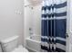 Clean bathroom with a white shower tub and blue and white striped shower curtain at 8423 Praise Dr, Tampa, FL 33625