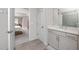 Bathroom featuring a single sink vanity and access to the primary bedroom at 8423 Praise Dr, Tampa, FL 33625