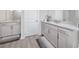 Bathroom features double vanity sinks with granite countertops and neutral cabinets at 8423 Praise Dr, Tampa, FL 33625