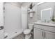 Bright bathroom features a walk-in shower with white tiling and a single vanity with marble countertop at 8423 Praise Dr, Tampa, FL 33625