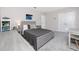 Bright bedroom with neutral decor, a grey bed, and desk setup offer a versatile and peaceful retreat at 8423 Praise Dr, Tampa, FL 33625