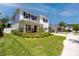 Well-maintained home featuring a green lawn, a covered porch, and stone accents at 8423 Praise Dr, Tampa, FL 33625
