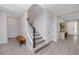 Inviting foyer with stylish wood-look tile flooring, a staircase, and a charming accent bench at 8423 Praise Dr, Tampa, FL 33625