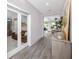 Long hallway with wood-look tile flooring, neutral walls, and an office view at 8423 Praise Dr, Tampa, FL 33625