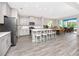Open-concept kitchen featuring a large island with seating and modern appliances at 8423 Praise Dr, Tampa, FL 33625