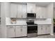 Modern kitchen with white cabinets, stainless steel appliances, and subway tile backsplash at 8423 Praise Dr, Tampa, FL 33625