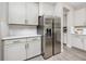 Kitchen features stainless steel refrigerator, tile backsplash, grey cabinets, and granite countertops at 8423 Praise Dr, Tampa, FL 33625