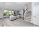 Bright living room with wood floors, recessed lighting, and large windows overlooking the landscaped front yard at 8423 Praise Dr, Tampa, FL 33625