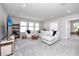 Bright living room featuring a plush sectional sofa, neutral color palette and three large windows at 8423 Praise Dr, Tampa, FL 33625