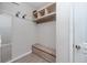 Functional mud room with built-in storage, hanging hooks, and tiled flooring for easy cleanup at 8423 Praise Dr, Tampa, FL 33625