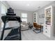 Sitting area with natural light, a treadmill, a chair, and a small desk at 8423 Praise Dr, Tampa, FL 33625