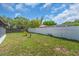 Large backyard with a white privacy fence and lush green lawn at 8501 56Th N St, Pinellas Park, FL 33781