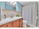 Renovated bathroom featuring a sleek vanity, designer tile, and shower with curtain at 8501 56Th N St, Pinellas Park, FL 33781