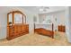 Bright bedroom featuring a wooden bed frame, matching dresser, and bedside table at 8501 56Th N St, Pinellas Park, FL 33781
