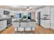 Bright kitchen with white cabinets, a large island, stainless steel appliances, and tiled backsplash at 8501 56Th N St, Pinellas Park, FL 33781