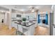 Modern kitchen featuring a large island, white cabinetry, stainless steel appliances, and a view of the yard at 8501 56Th N St, Pinellas Park, FL 33781