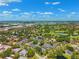 Scenic aerial perspective of a neighborhood blending residential living with natural landscape elements at 8645 Piper Ln, Seminole, FL 33777