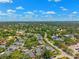Extensive aerial view capturing a large residential area with lush greenery and a network of roads at 8645 Piper Ln, Seminole, FL 33777
