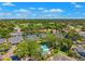 Picturesque aerial view showcases residential neighborhood with lush greenery and community golf course at 8645 Piper Ln, Seminole, FL 33777