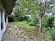 Lush backyard space features mature trees and green shrubs, offering a private outdoor setting at 8645 Piper Ln, Seminole, FL 33777