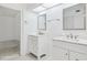 Bathroom featuring dual vanities with marble countertops, modern fixtures, and an adjacent room at 8645 Piper Ln, Seminole, FL 33777