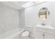 Bathroom featuring white subway tile, modern fixtures, and a shower-tub combination with a white sink at 8645 Piper Ln, Seminole, FL 33777