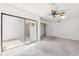 Bright bedroom with large sliding glass doors and a ceiling fan at 8645 Piper Ln, Seminole, FL 33777