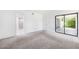 Spacious carpeted bedroom with sliding glass doors to the outside, creating a seamless indoor-outdoor flow at 8645 Piper Ln, Seminole, FL 33777