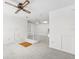 Bright bonus room area with a ceiling fan and staircase at 8645 Piper Ln, Seminole, FL 33777