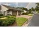 Charming single-story home with manicured landscaping, spacious driveway, and visible rainbow in the background at 8645 Piper Ln, Seminole, FL 33777