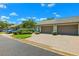 Welcoming exterior showcases a double garage, attractive brick driveway, and manicured front yard at 8645 Piper Ln, Seminole, FL 33777