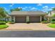 Attractive home with a double garage door, brick-paved driveway, and tidy landscaping at 8645 Piper Ln, Seminole, FL 33777