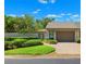 Well-maintained home with updated landscaping and a brick driveway leading to the garage at 8645 Piper Ln, Seminole, FL 33777