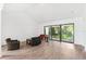 Open living room with a vaulted ceiling and glass sliding doors providing ample natural light at 8645 Piper Ln, Seminole, FL 33777