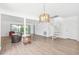 Bright, open floor plan with sliding glass doors and modern spiral staircase at 8645 Piper Ln, Seminole, FL 33777