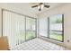 Inviting sunroom with tiled floors and large windows overlooking the backyard at 8645 Piper Ln, Seminole, FL 33777