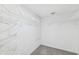 Bright walk-in closet with ample wire shelving for storage and organization with carpeted floor at 8645 Piper Ln, Seminole, FL 33777