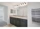 Bathroom boasts double sinks with granite counters and modern lighting at 9508 Pyrenees Pl, Seffner, FL 33584