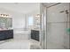 Bathroom featuring double sink vanities, a soaking tub, glass shower, and neutral decor at 9508 Pyrenees Pl, Seffner, FL 33584