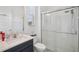 Modern bathroom with a glass shower and a dark vanity at 9508 Pyrenees Pl, Seffner, FL 33584