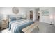 Inviting bedroom with a cozy bed, stylish bedside tables, decorative mirror, and a light-colored geometric rug at 9508 Pyrenees Pl, Seffner, FL 33584