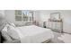 Bright bedroom featuring a large window, neutral walls, carpeted floor, and an elegant mirrored dresser at 9508 Pyrenees Pl, Seffner, FL 33584