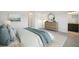 Cozy bedroom features a dresser, stylish decor, and an ensuite bathroom entrance at 9508 Pyrenees Pl, Seffner, FL 33584