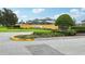 Beautiful community entrance with landscaping, manicured bushes and green grass at 9508 Pyrenees Pl, Seffner, FL 33584