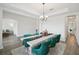 Formal dining room featuring a decorative table runner, comfortable green chairs and modern decor at 9508 Pyrenees Pl, Seffner, FL 33584