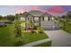 Beautiful two-story home featuring manicured lawn, stone accents, three-car garage, and long driveway at 9508 Pyrenees Pl, Seffner, FL 33584
