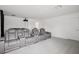 Home theater with tiered seating, projector, plush carpet, and a door leading to another room at 9508 Pyrenees Pl, Seffner, FL 33584